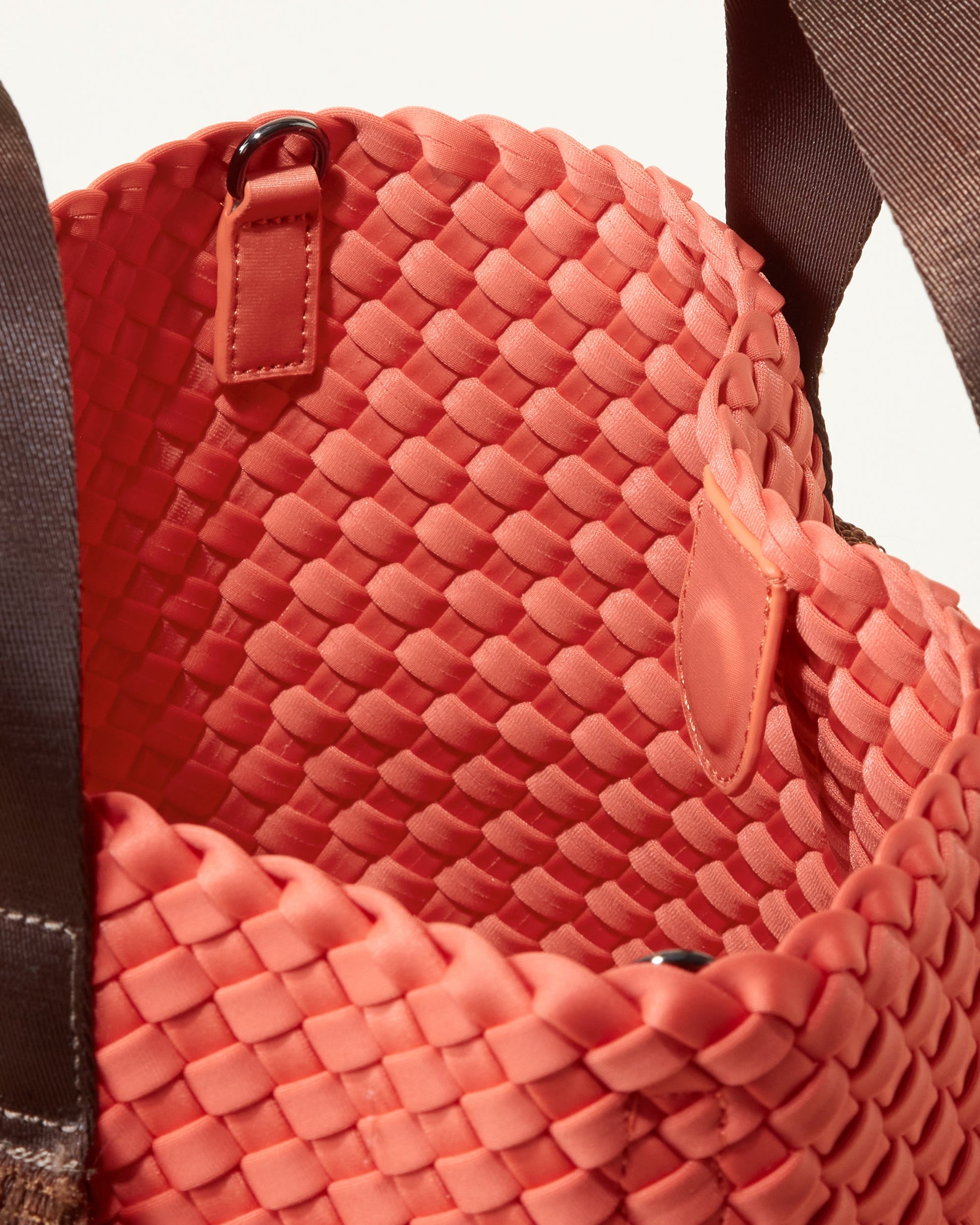 A woven texture crossbody bag with a structured flap and slender strap—evoking coastal charm with tactile appeal and refined artistry-1