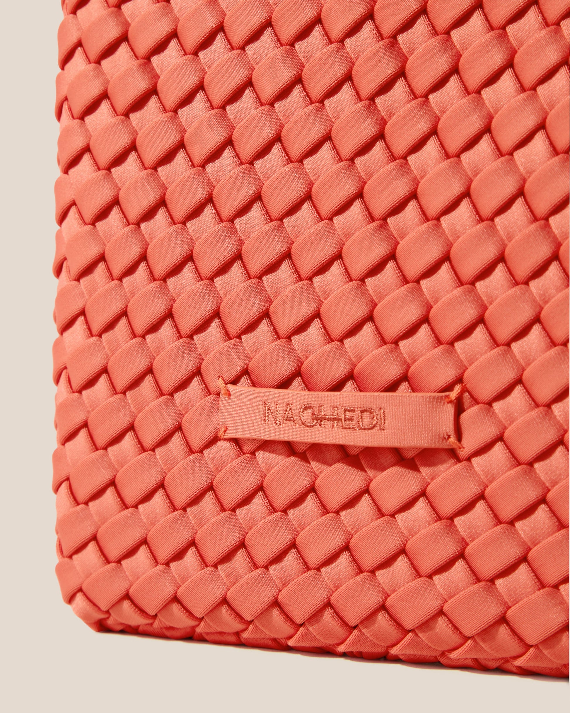 A woven texture crossbody bag with a structured flap and slender strap—evoking coastal charm with tactile appeal and refined artistry-3