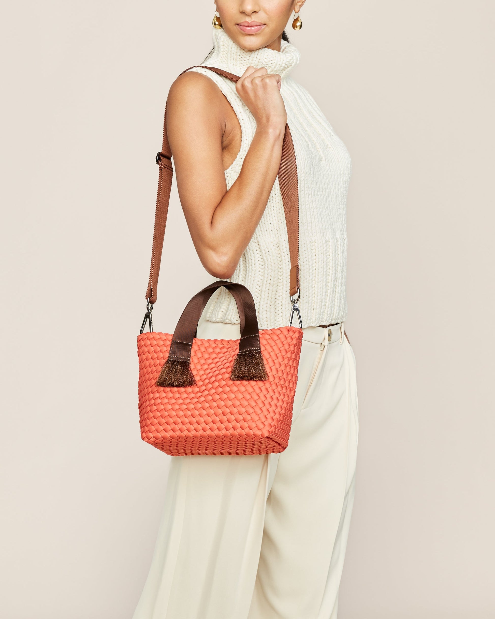A woven texture crossbody bag with a structured flap and slender strap—evoking coastal charm with tactile appeal and refined artistry-4