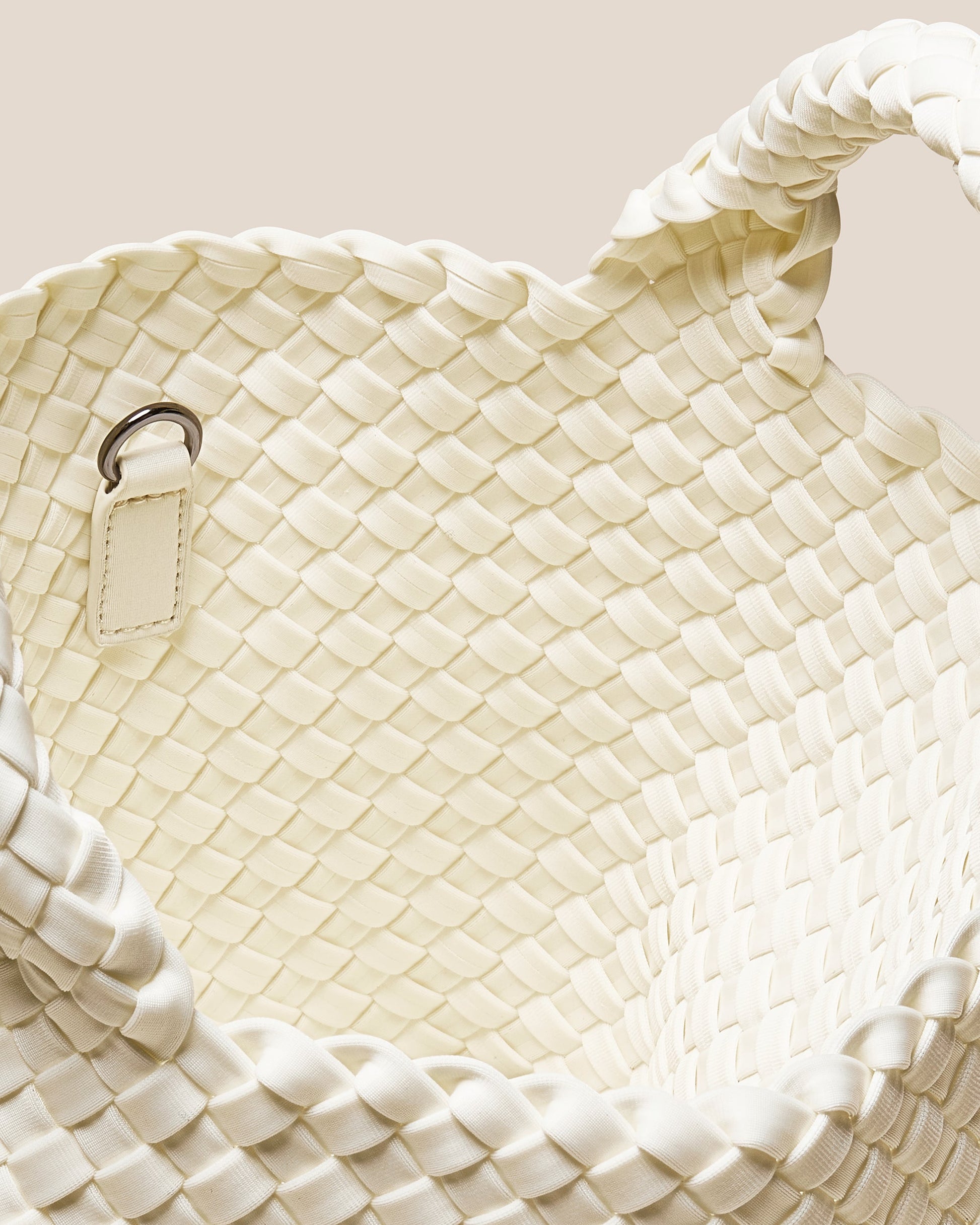 A beautifully crafted Jasmine crossbody bag featuring woven textures, compact flap closure, and elegant tassel details—embodying artisanal design and refined style-1