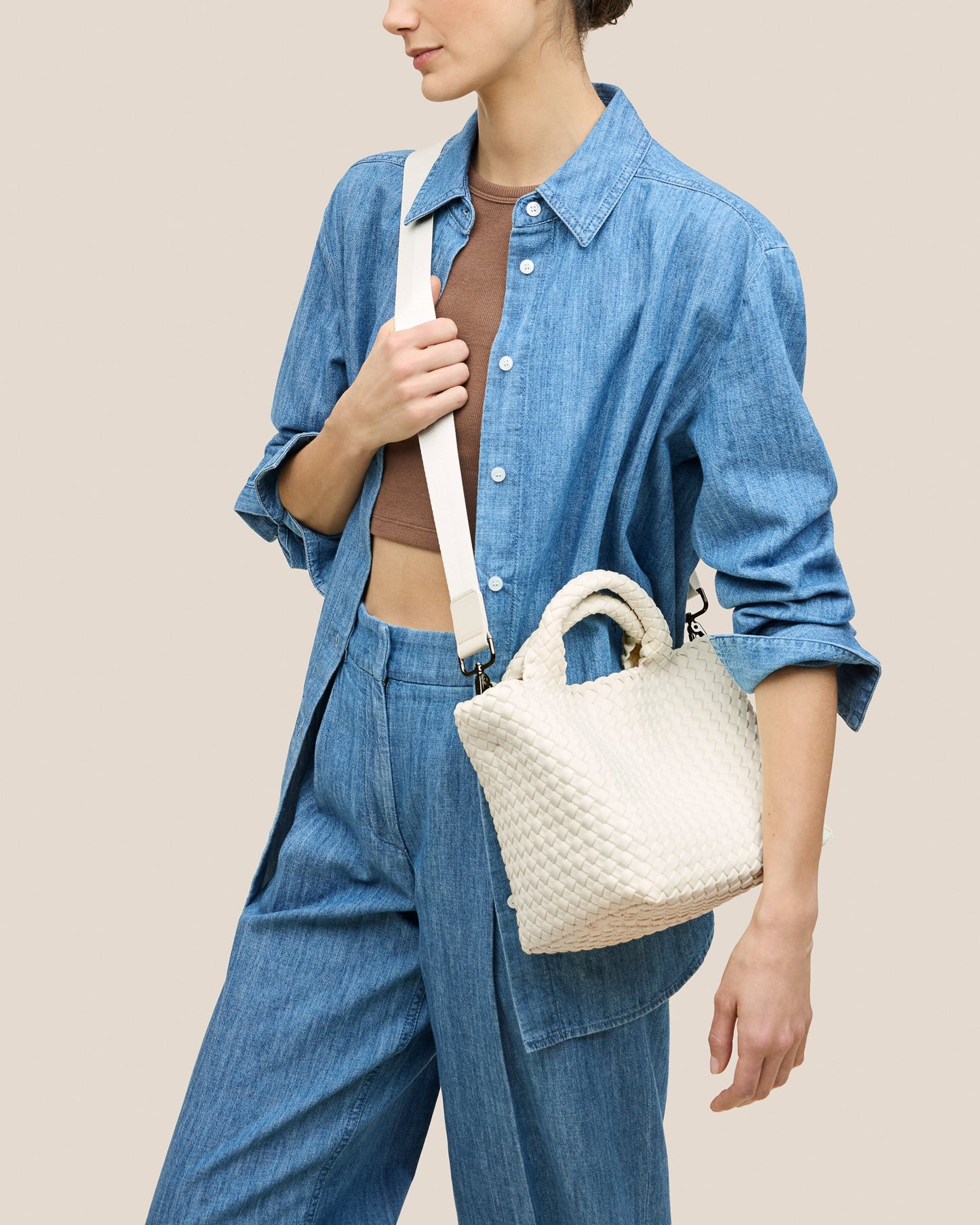 A beautifully crafted Jasmine crossbody bag featuring woven textures, compact flap closure, and elegant tassel details—embodying artisanal design and refined style-4