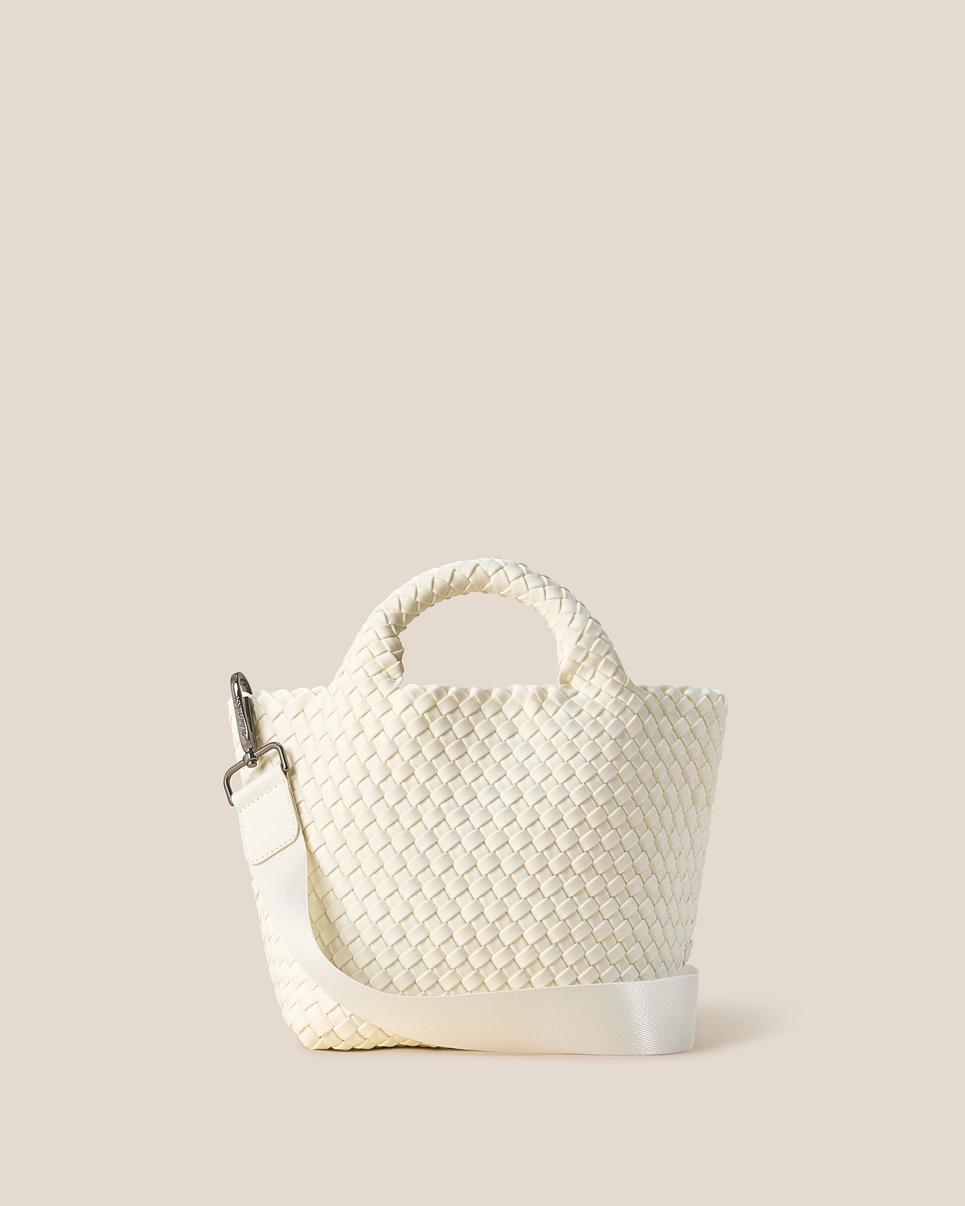 A beautifully crafted Jasmine crossbody bag featuring woven textures, compact flap closure, and elegant tassel details—embodying artisanal design and refined style