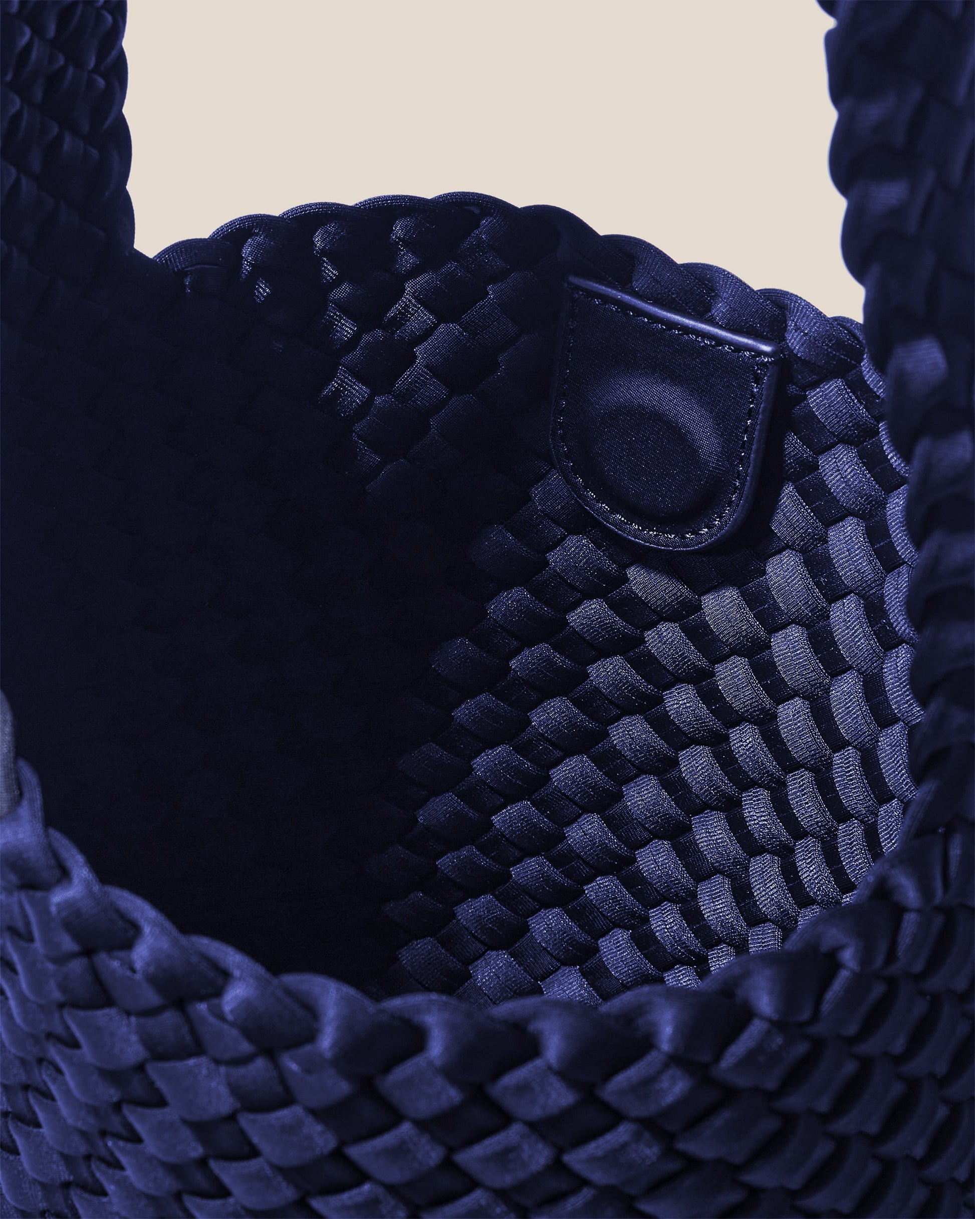 Valnera Vista Laguna ink blue crossbody bag with handwoven neoprene texture, deep navy hue, and slender strap—exuding coastal cool style with artisanal elegance-1