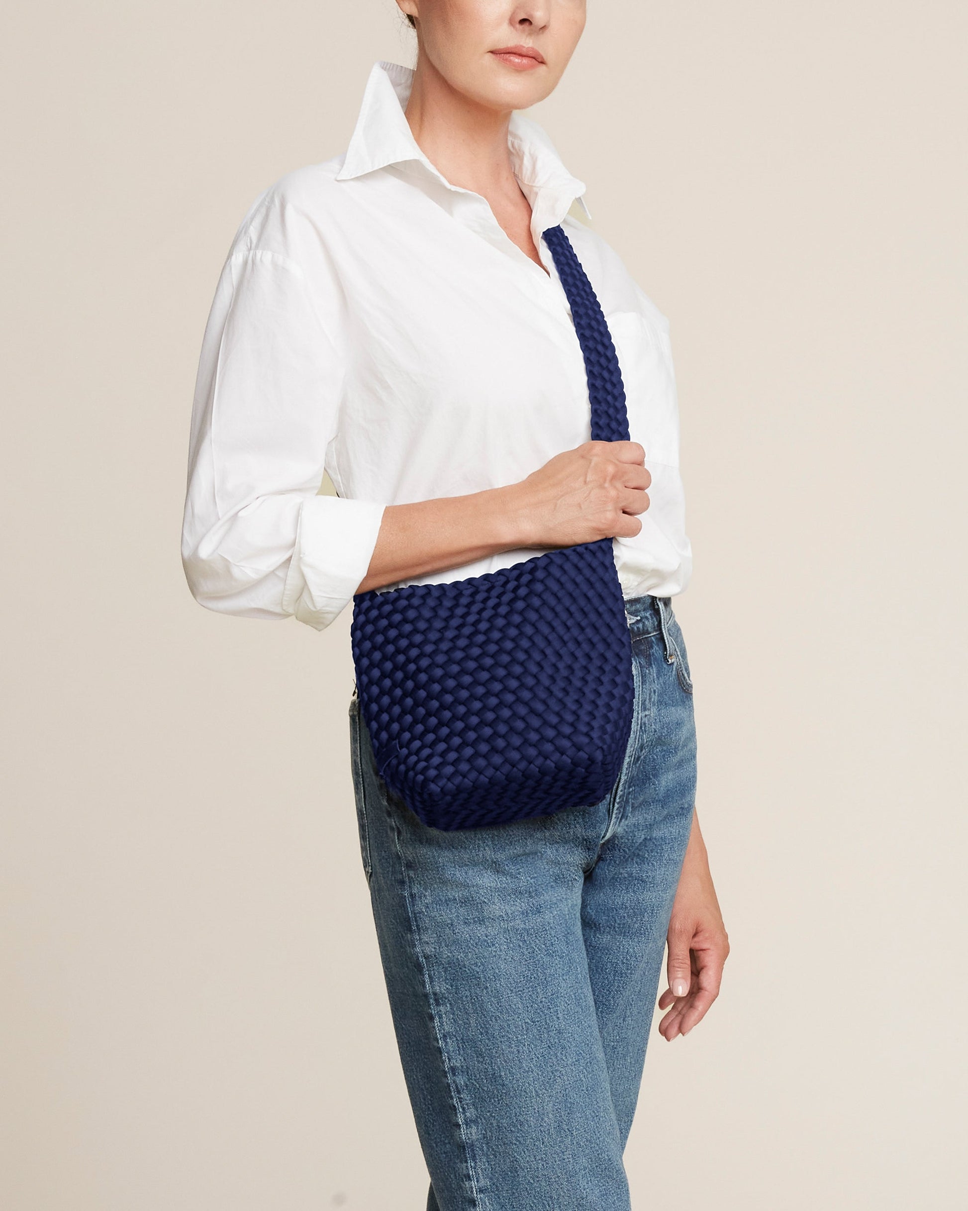 Valnera Vista Laguna ink blue crossbody bag with handwoven neoprene texture, deep navy hue, and slender strap—exuding coastal cool style with artisanal elegance-2