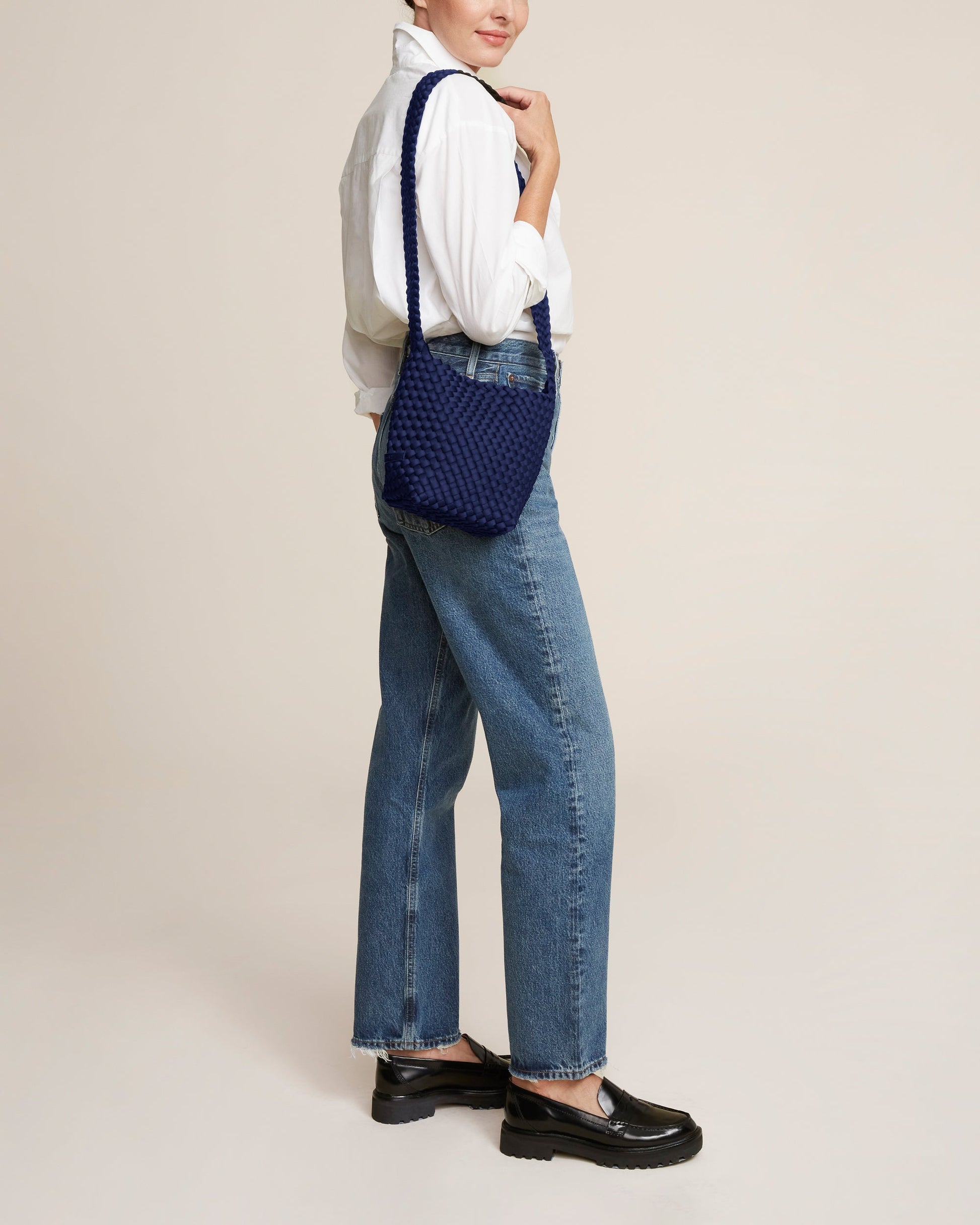 Valnera Vista Laguna ink blue crossbody bag with handwoven neoprene texture, deep navy hue, and slender strap—exuding coastal cool style with artisanal elegance-3