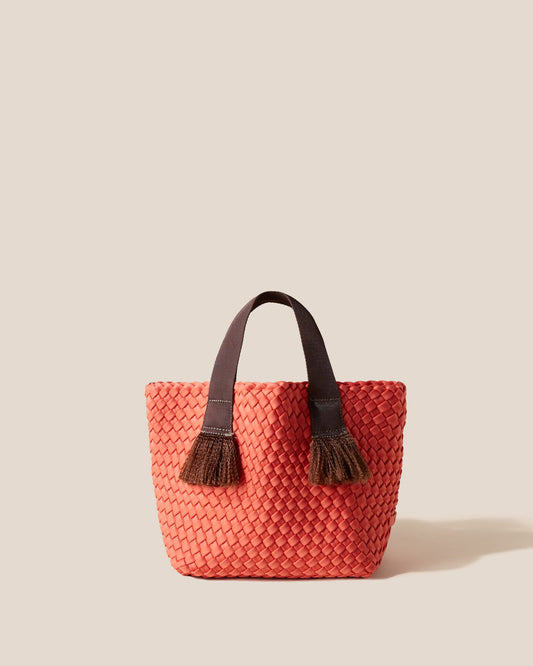 A woven texture crossbody bag with a structured flap and slender strap—evoking coastal charm with tactile appeal and refined artistry