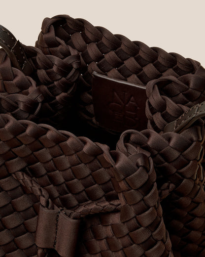 A rich chocolate-toned crossbody bucket bag featuring handwoven neoprene texture, drawstring closure, and adjustable leather strap—showcasing artisanal craftsmanship and tactile elegance by Valnera Vista-1