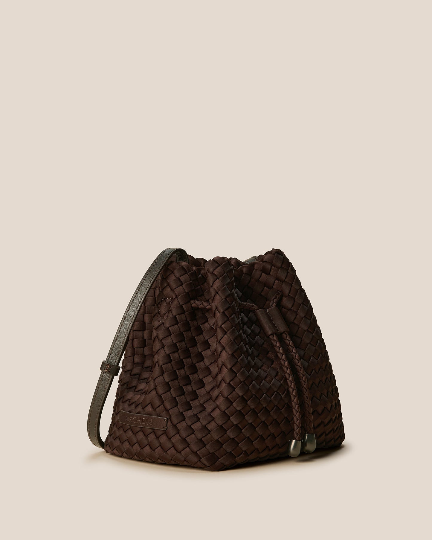 A rich chocolate-toned crossbody bucket bag featuring handwoven neoprene texture, drawstring closure, and adjustable leather strap—showcasing artisanal craftsmanship and tactile elegance by Valnera Vista-3