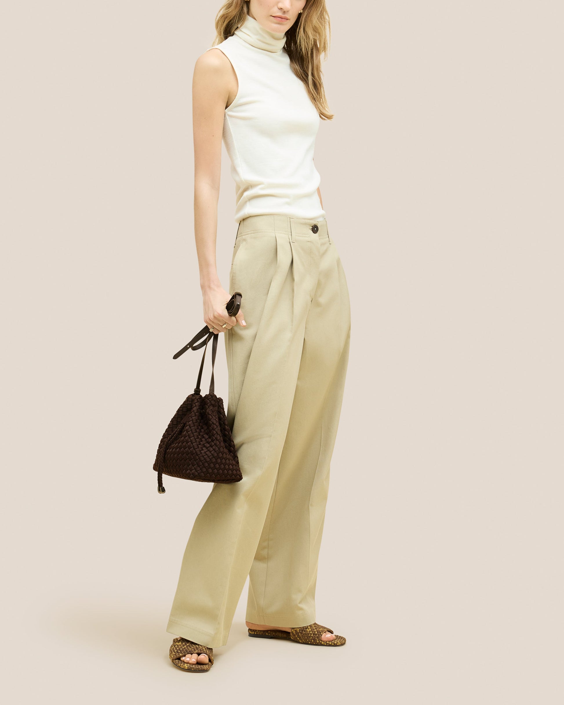 A rich chocolate-toned crossbody bucket bag featuring handwoven neoprene texture, drawstring closure, and adjustable leather strap—showcasing artisanal craftsmanship and tactile elegance by Valnera Vista-4